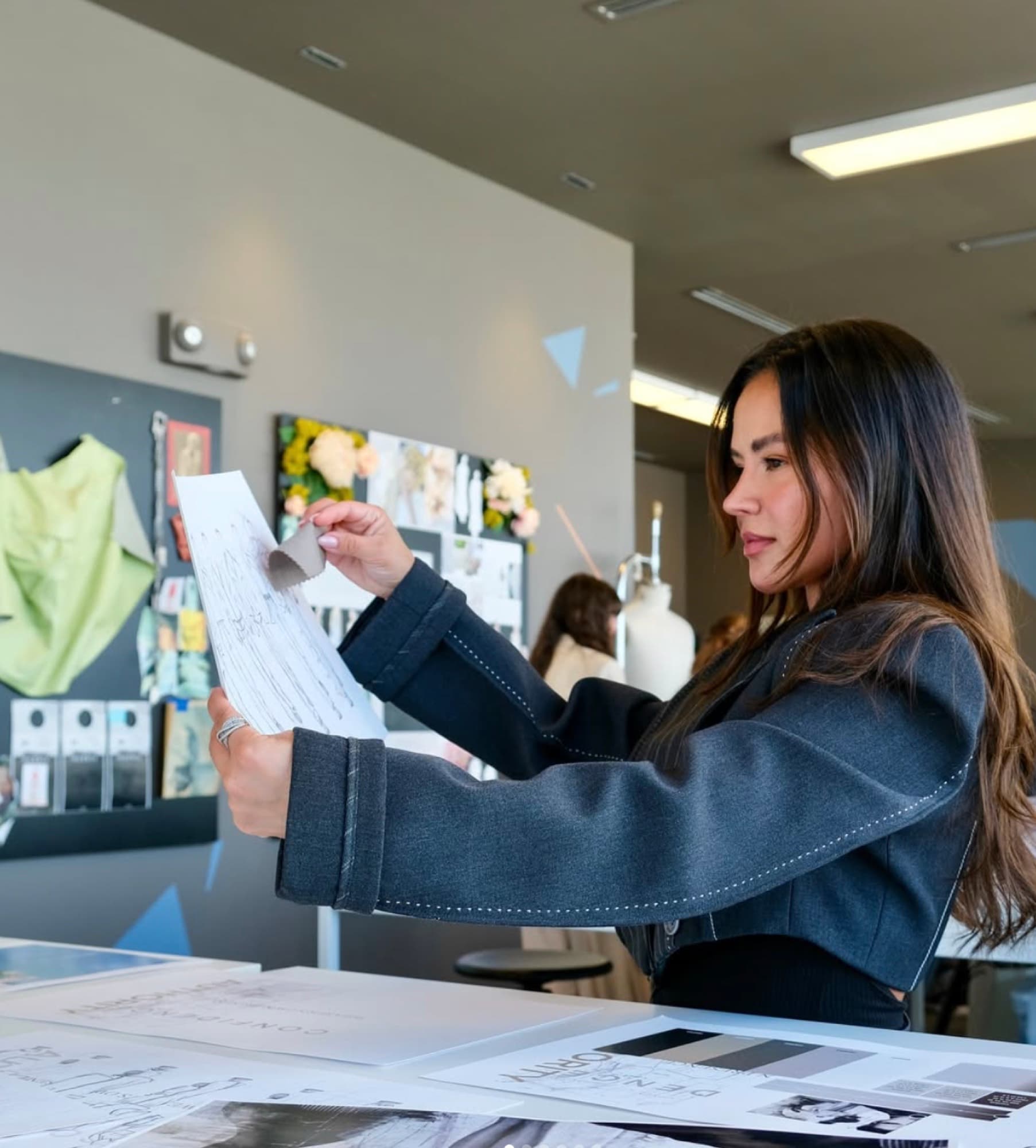 Portrait — Paloma Balvin reviewing sketches and swatches in the atelier