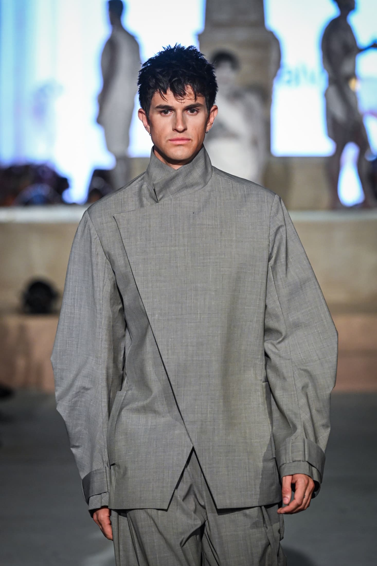 Closer view of the grey high-neck jacket with its crossed front panel — Miami Design District