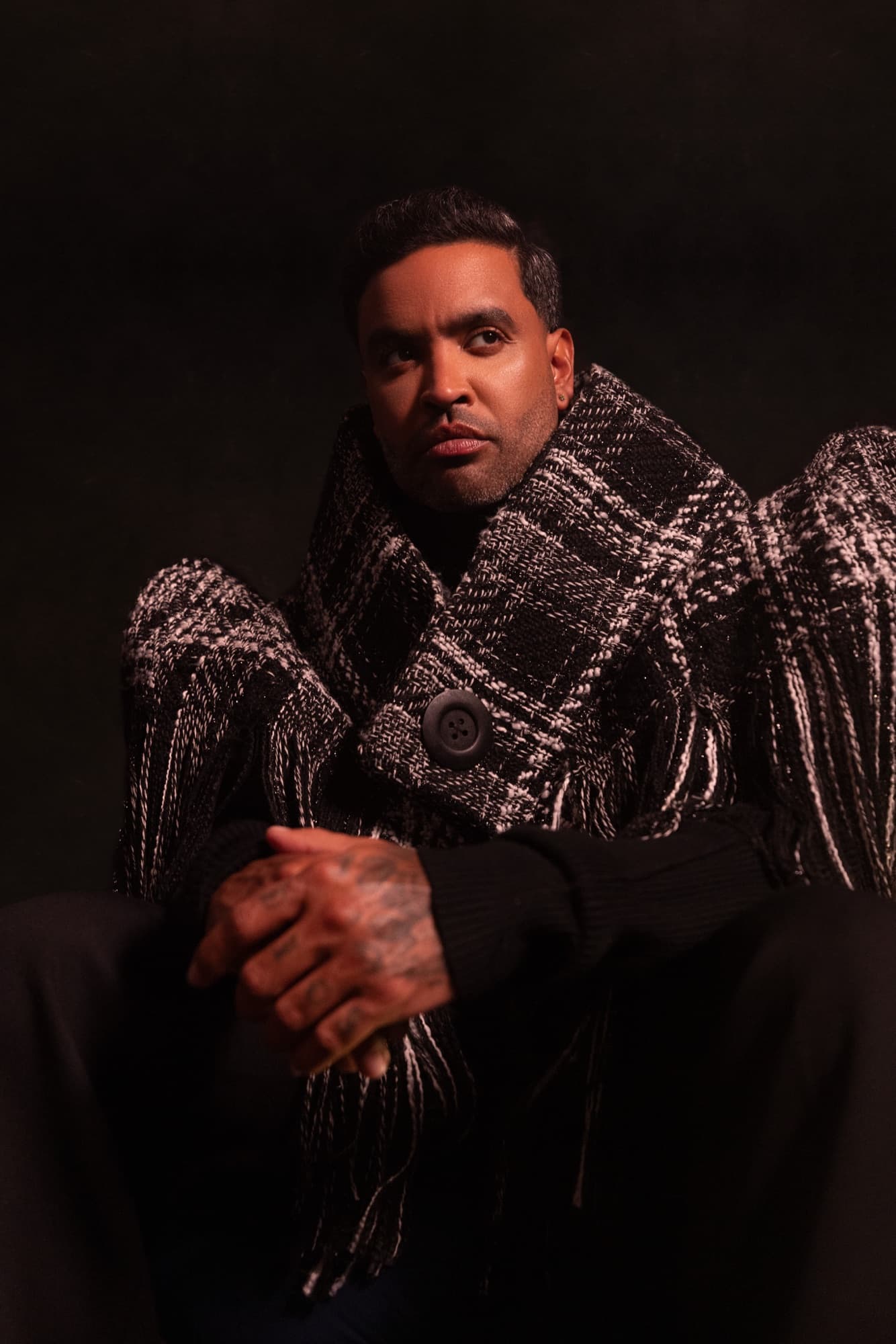 Zion in a fringed black and white tweed shawl over a black knit — styled by Paloma Balvin for L'Officiel Baltic