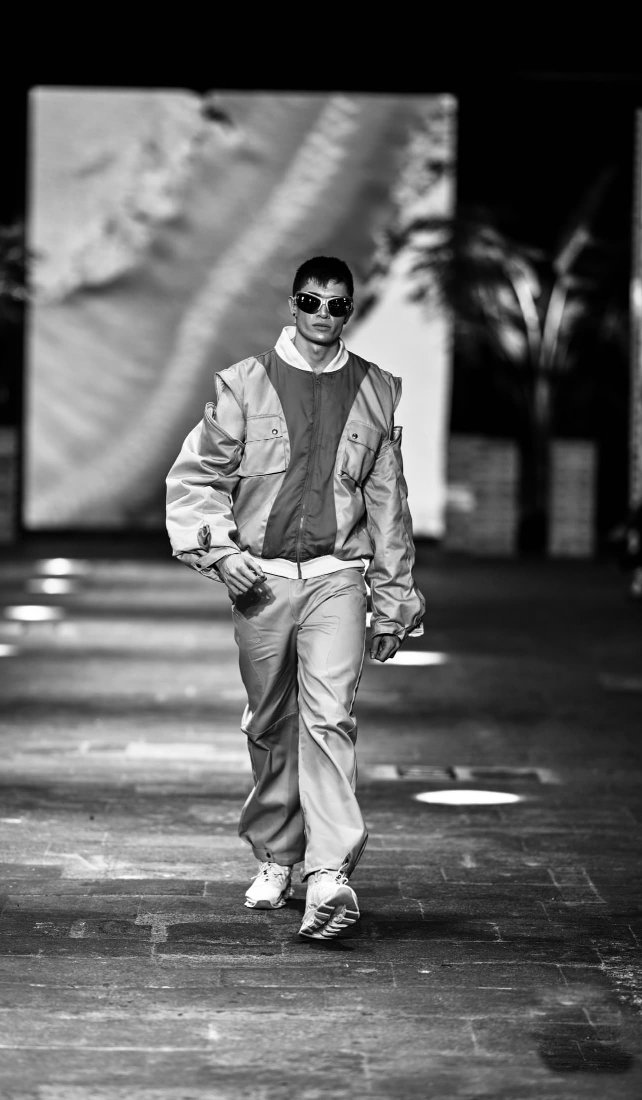 Model in a grey and charcoal colour-blocked jacket with cropped trousers — Costa Rica Fashion Week