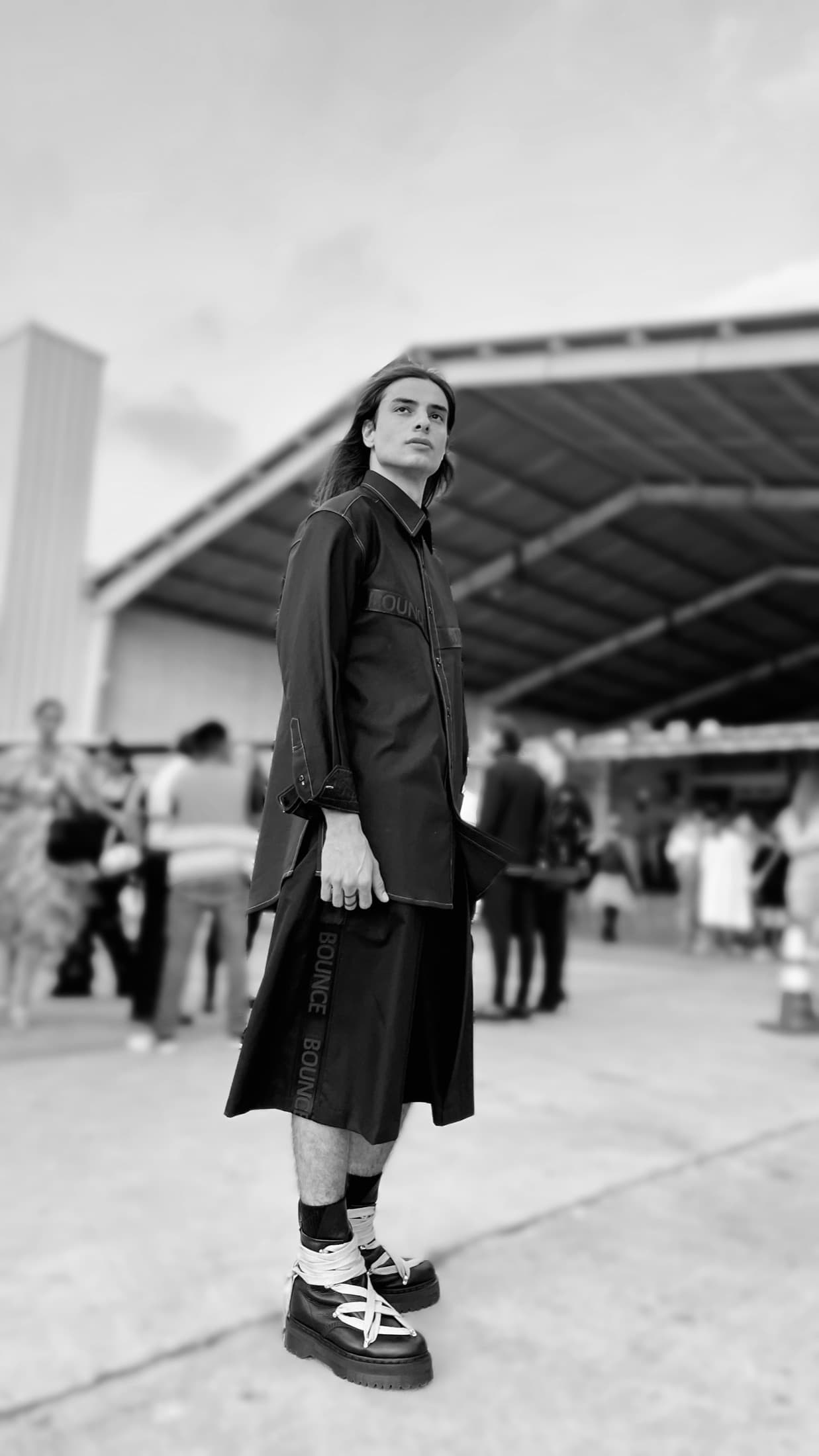 Model in a hand-painted bomber jacket, seen from behind on the runway — Semana de la Moda, Guatemala